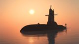 Surfaced submarine in the water at sunset