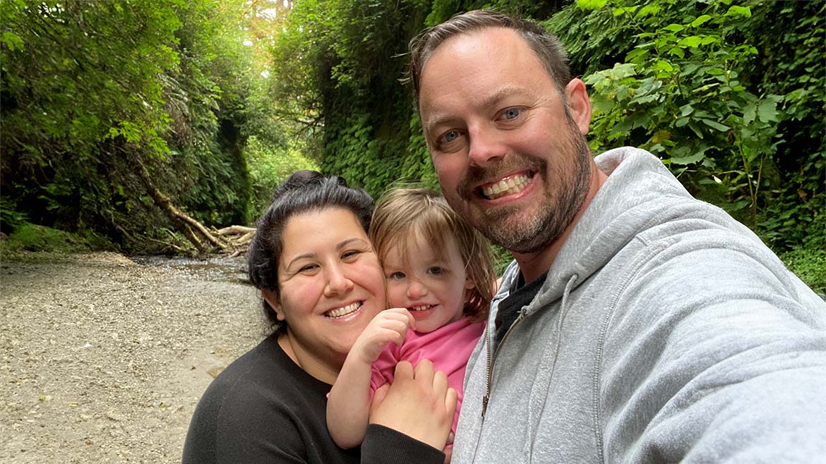 Justin Wise with wife and daughter on a hike.
