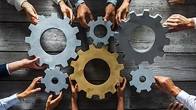 Vision & Sensors Integration feature image of business people joining gears.