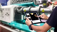 Integrated and connected machine vision systems Worker on tablet accessing data.