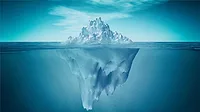 A view of an iceberg above and below the water.