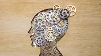 Brain model concept Brain model concept made from gears and cogwheels on wooden background.