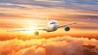Airplane above the clouds in the sky at sunrise. Airplane above the clouds in the sky at sunrise.