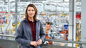 Female engineer standing in automobile industry.
