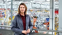 Female engineer standing in automobile industry.