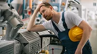 Factory worker having problem with production line Factory worker having a problem in the production line.