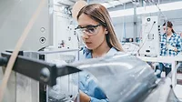 Female industrial worker working with manufacturing equipment in a factory Female industrial worker working with manufacturing equipment in a factory.
