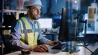 Electronics Design Factory: Male Engineer Wearing Safety Vest Working on Computer.