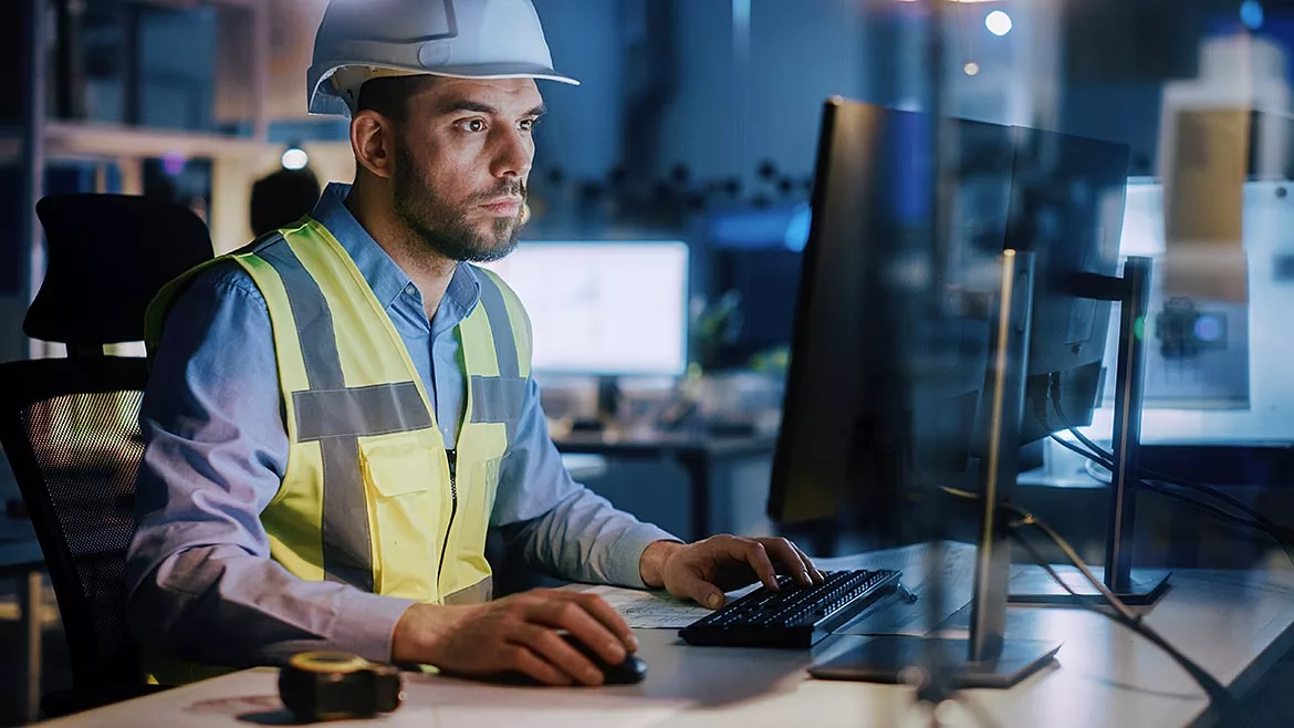 Electronics Design Factory: Male Engineer Wearing Safety Vest Working on Computer.