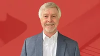 Buck Bicek retires from Quality Buck Bicek portrait with red background.