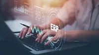 Person using a laptop with document management for ERP Person using a laptop with document management for ERP. Enterprise resource planning concept