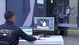 An engineer monitoring a robotic CT scan and analysis system as it inspects a manufactured component. Image courtesy of Heitec
