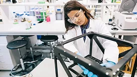Female scientist is intently focused on perfecting the design of the prototype.