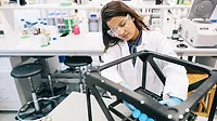 Female scientist is intently focused on perfecting the design of the prototype.