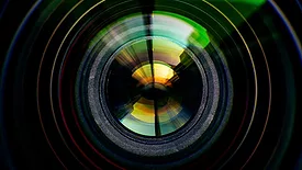 Close-up of camera lens on black background.
