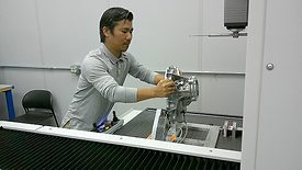 Quality Auditor Kam Khai prepares to measure a part with a ZEISS PRISMO ultra CMM.