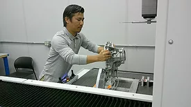 Quality Auditor Kam Khai prepares to measure a part with a ZEISS PRISMO ultra CMM.