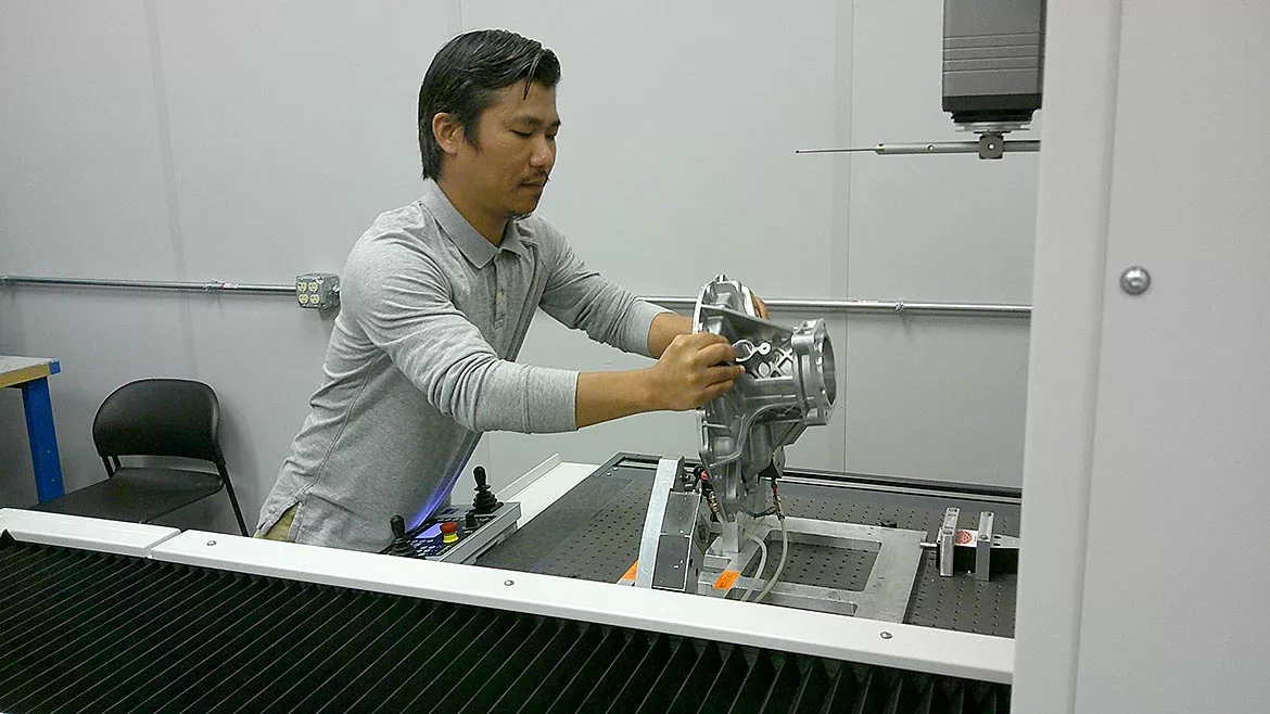 Quality Auditor Kam Khai prepares to measure a part with a ZEISS PRISMO ultra CMM.