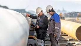 Non-destructive testing technicians checking welds of pipes with the ultrasonic testing (UT) method Non-destructive testing technicians are checking the welds of pipes with the ultrasonic testing (UT) method. Ultrasonic testing is often performed on steel and other metals and alloys.