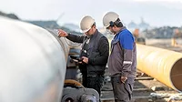 Non-destructive testing technicians checking welds of pipes with the ultrasonic testing (UT) method Non-destructive testing technicians are checking the welds of pipes with the ultrasonic testing (UT) method. Ultrasonic testing is often performed on steel and other metals and alloys.