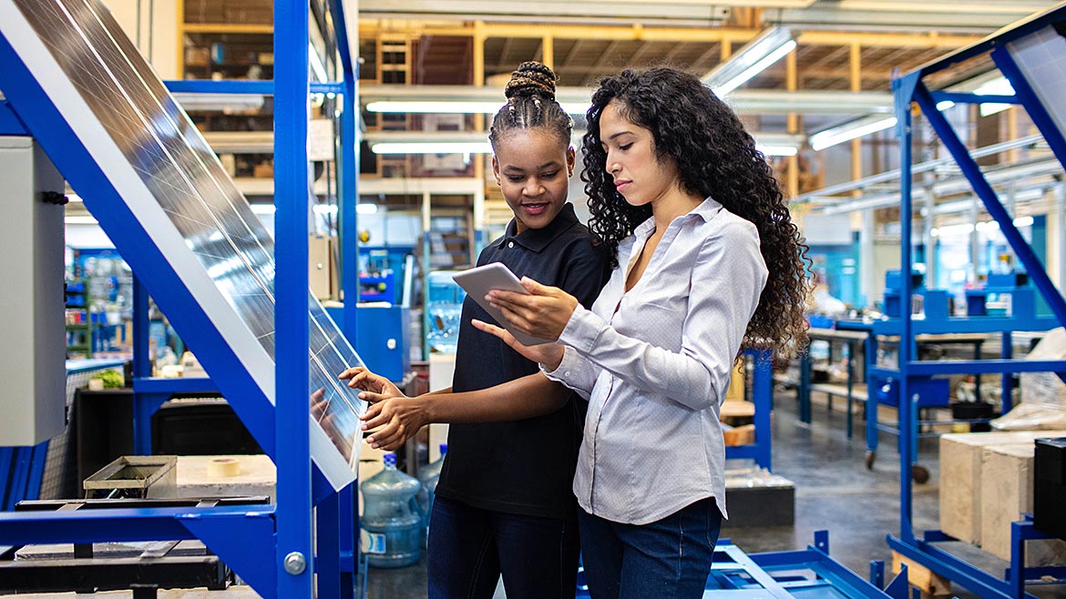 Two female engineers looking at a tablet