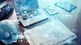 Industrial technology concept layed over a work desk with a laptop, hardhat, glasses, table, folder on top.