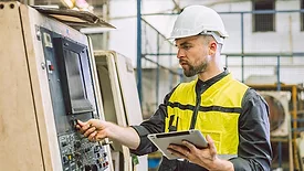 Engineer worker using digital tablet in a factory.