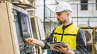 Engineer worker using digital tablet in a factory.