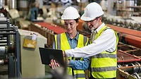 The project manager and engineer inspect workpieces and verify standards and safety protocols for products and ensure safety in the factory.