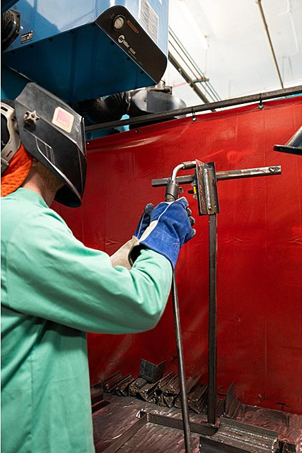 Student in protective headgear welding