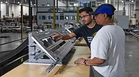 Two quality employees looking at equipment Two quality employees looking at equipment