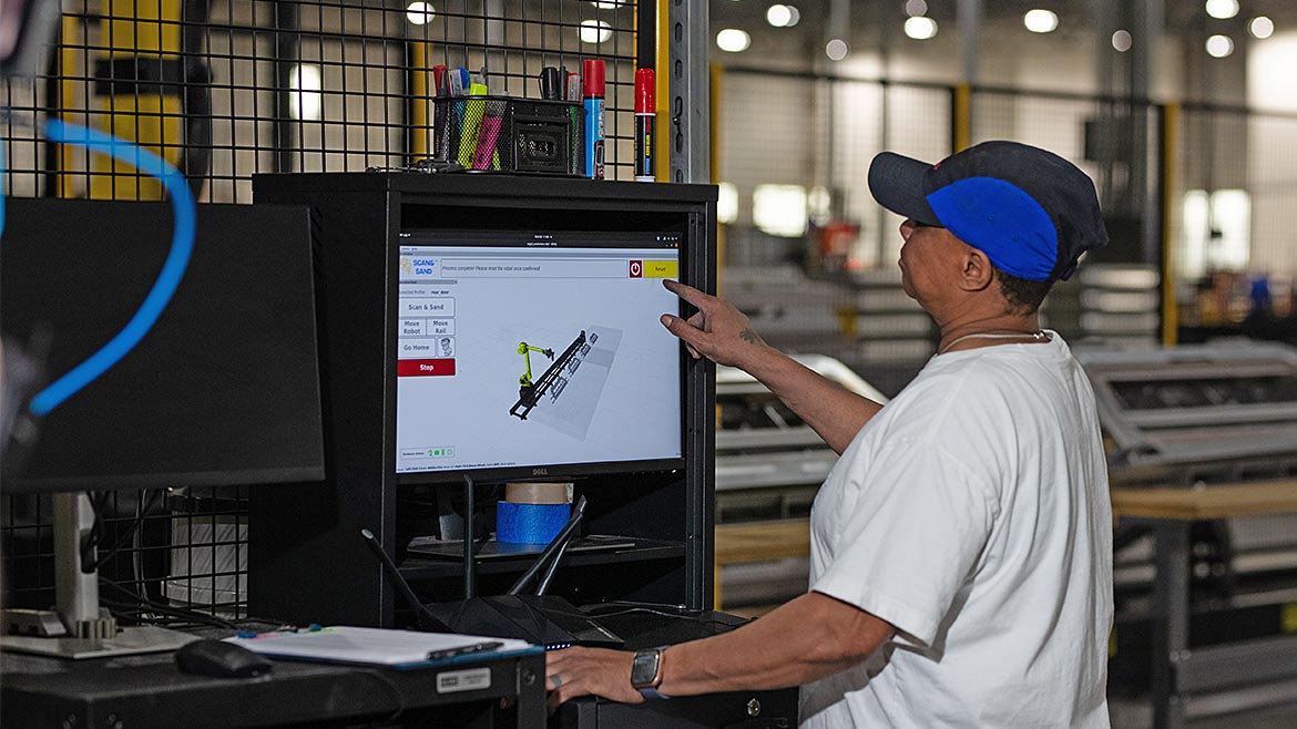 Employee pointing at a monitor screen.