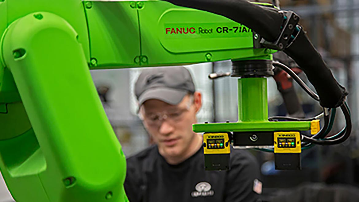 Employee working with a collaborative robot.