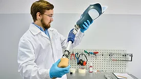 Young Prosthetist Holding Artificial Leg