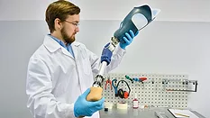 Young Prosthetist Holding Artificial Leg