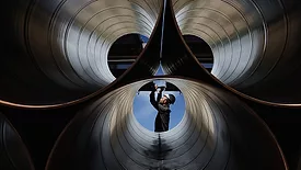 An engineer checking industrial pipes.