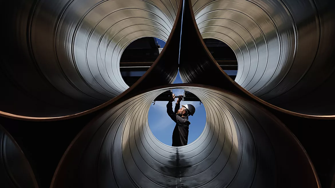 An engineer checking industrial pipes.