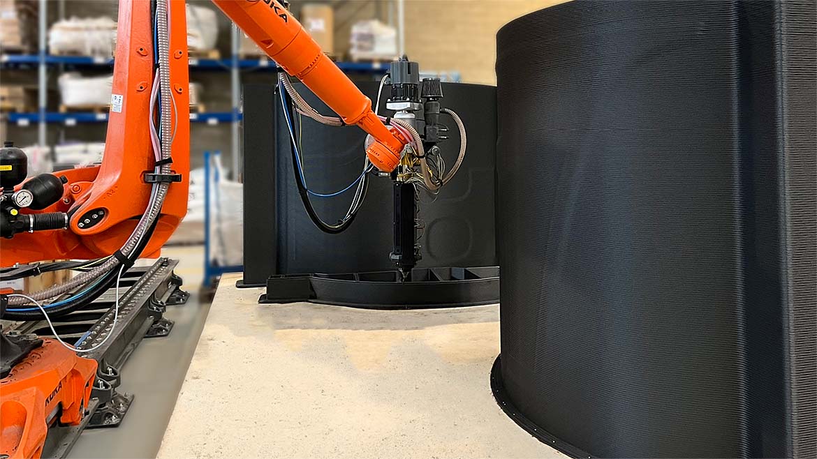 Orange robotic arm used in large format additive manufacturing.