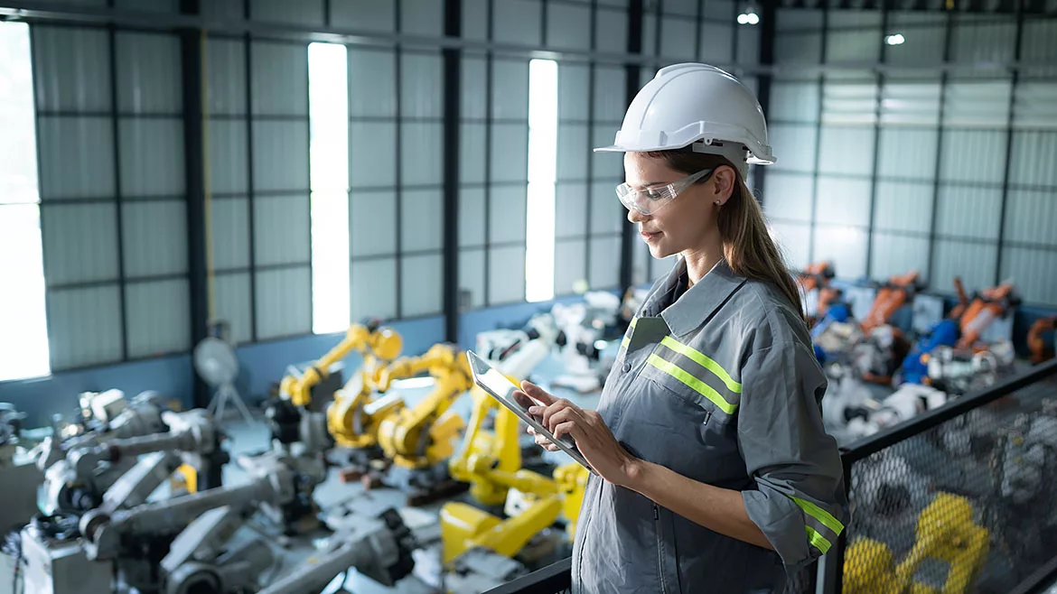 A female auditor inspects the company's robot assets in the warehouse before delivering them to customers.