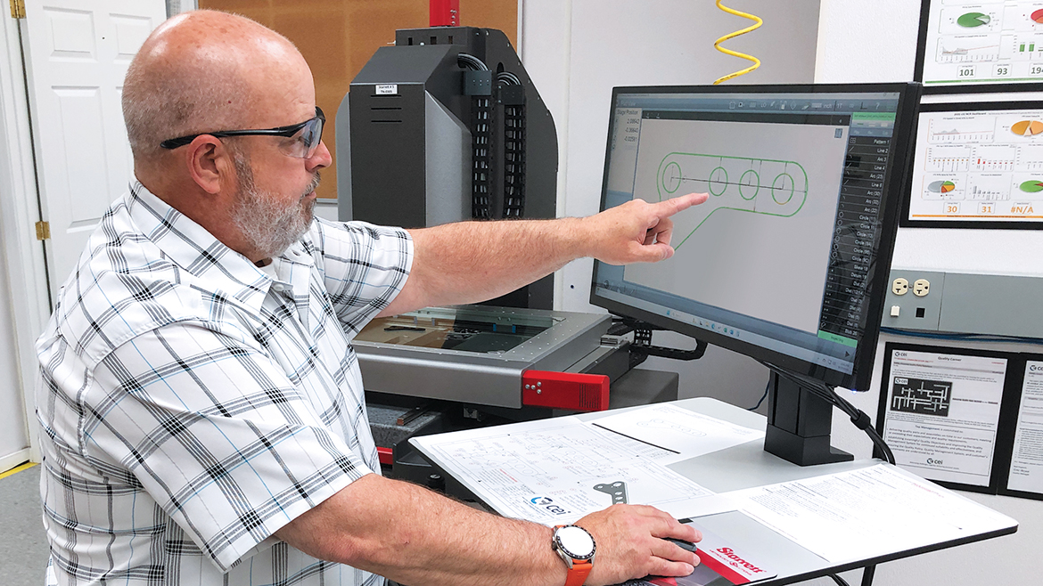 Eric Boyea, CEI Quality Manager, checking the precise profile of stamped inserts.