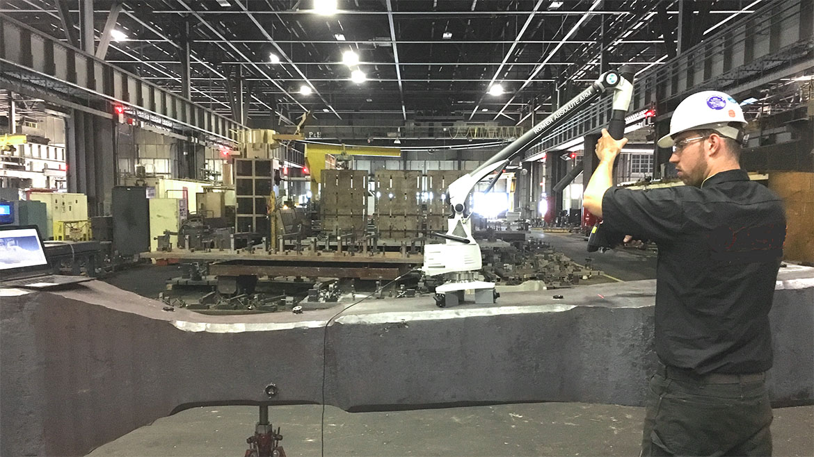 Metrologist uses articulated arm in mill.
