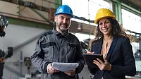 Female engineering manager and mechanic worker doing routine check up in industrial factory Female engineering manager and mechanic worker doing routine check up in industrial factory