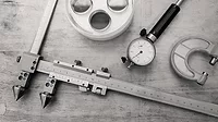 Metal measuring instruments on a wooden table.