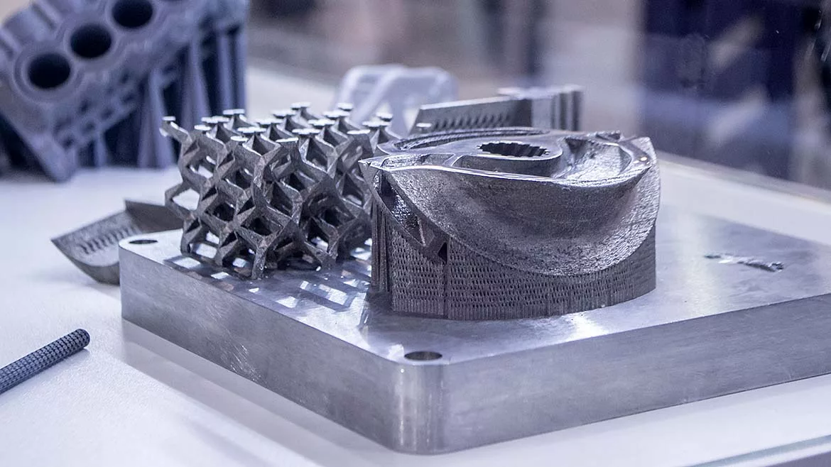 Man is holding object printed on metal 3d printer.