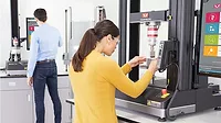 Operators perform materials analysis on universal testing equipment