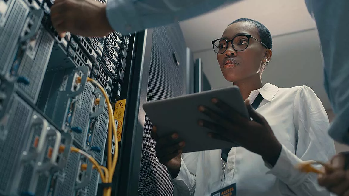 Shot of a man and woman using a digital tablet while working in a data centre.