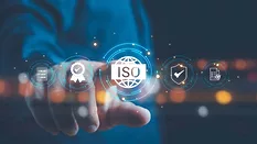 Cropped and blurred image of a man touching the screen with ISO and globe icons on smart background.