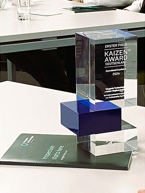 Operational Excellence Award at the 2024 German Kaizen Awards sitting on a white desk.