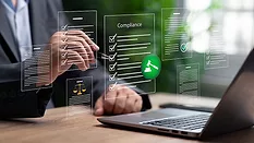 Cropped image businessperson touching a pen to a virtual Compliance checklist. Other virtual documents float above a laptop.