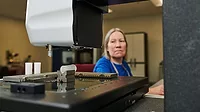 a woman working in an industrial or manufacturing setting a woman working in an industrial or manufacturing setting
